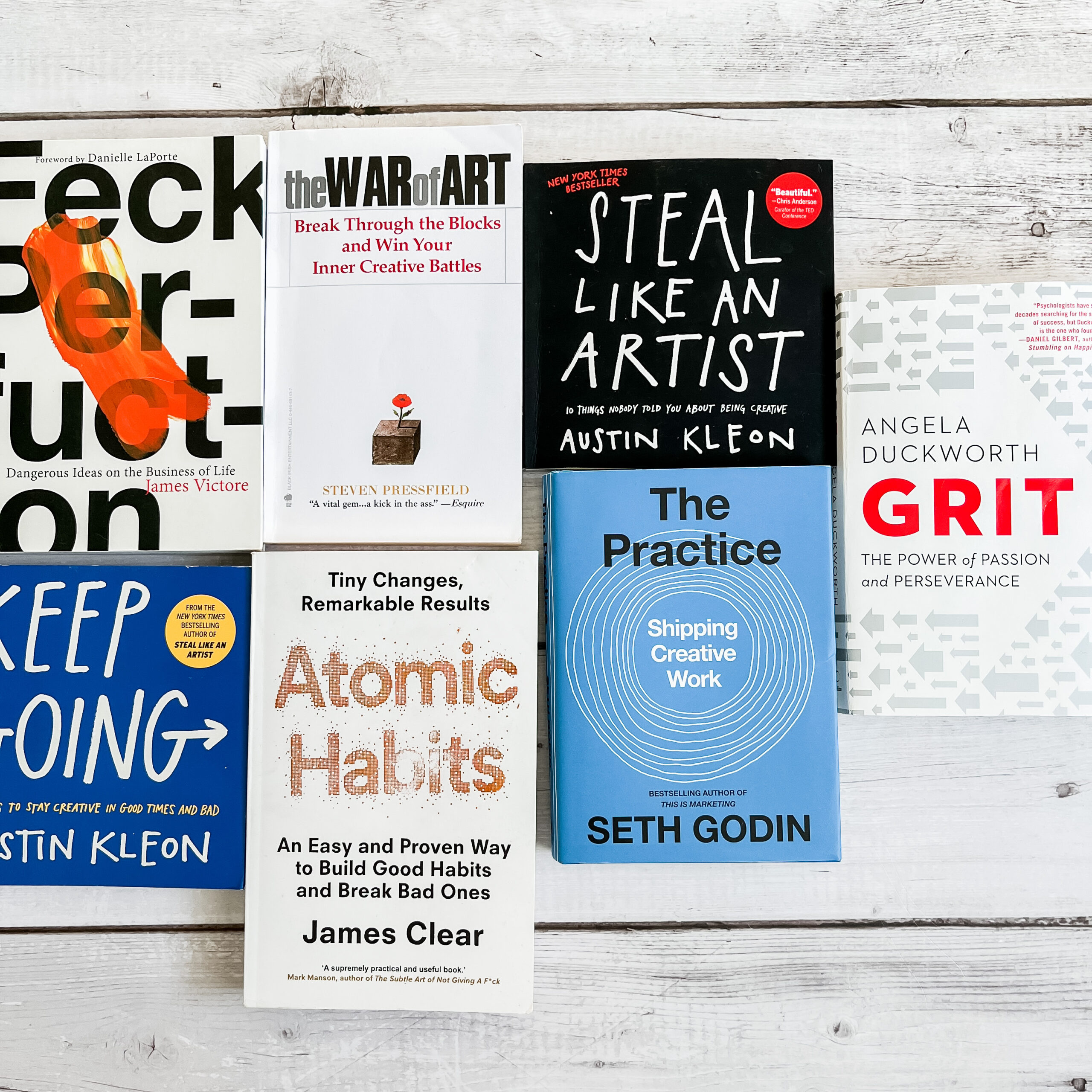 7 books on creativity sitting on a wooden surface