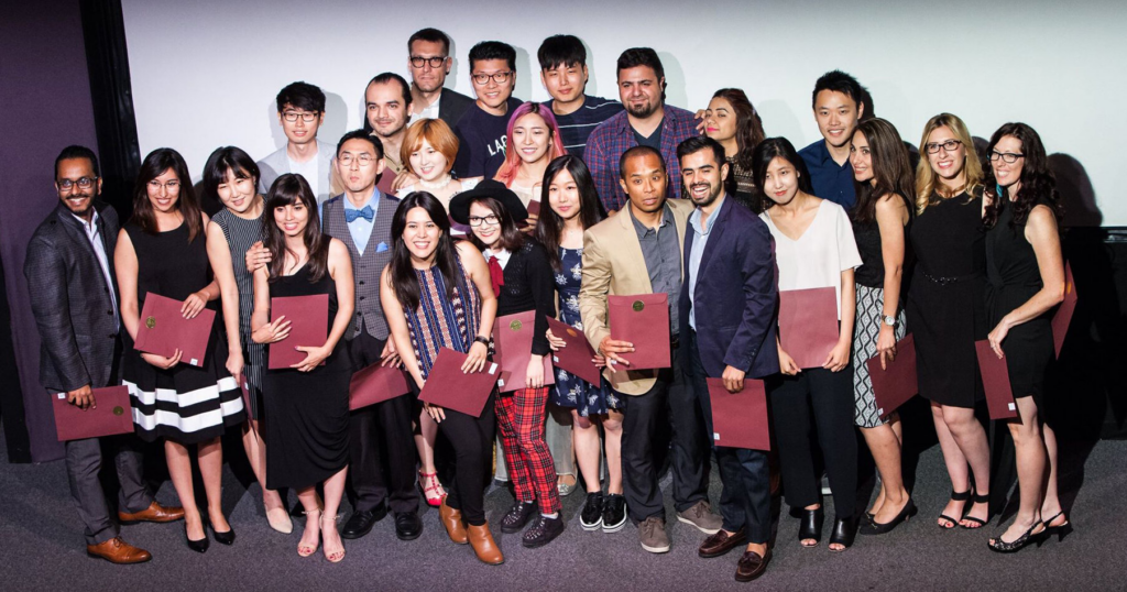 Group of full time motion designers & illustrators holding diplomas at graduation